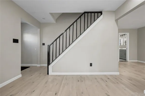 a view of an entryway with wooden floor