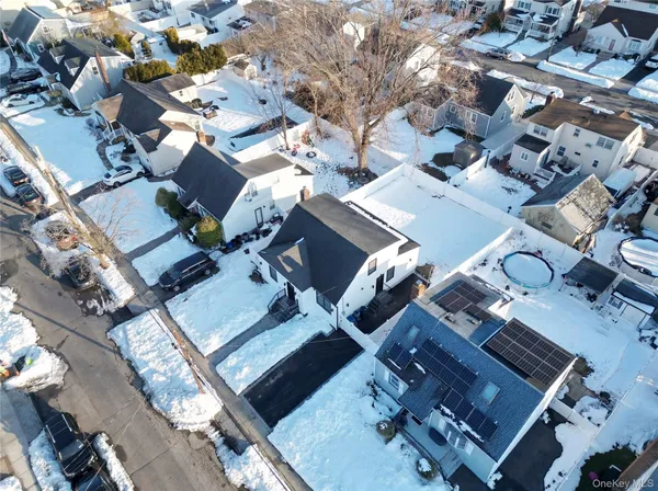 an aerial view of a residential building with parking