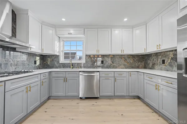 a kitchen with cabinets appliances and a counter top space