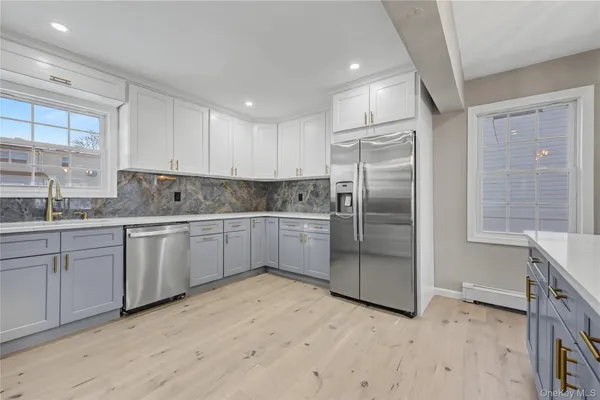 a kitchen with a refrigerator sink and cabinets