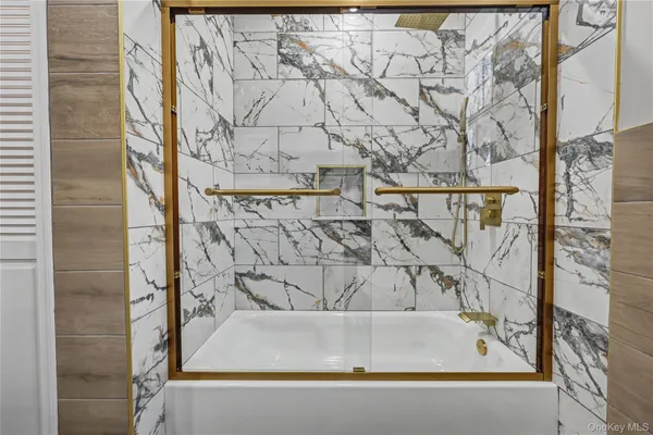 a bathroom with a bathtub and shower