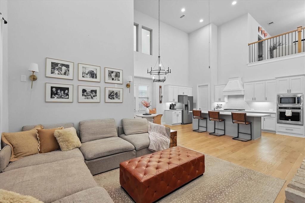 618 Race Drive Forney, TX 75126 - Photo 12 of 39 a living room with furniture kitchen view and a chandelier