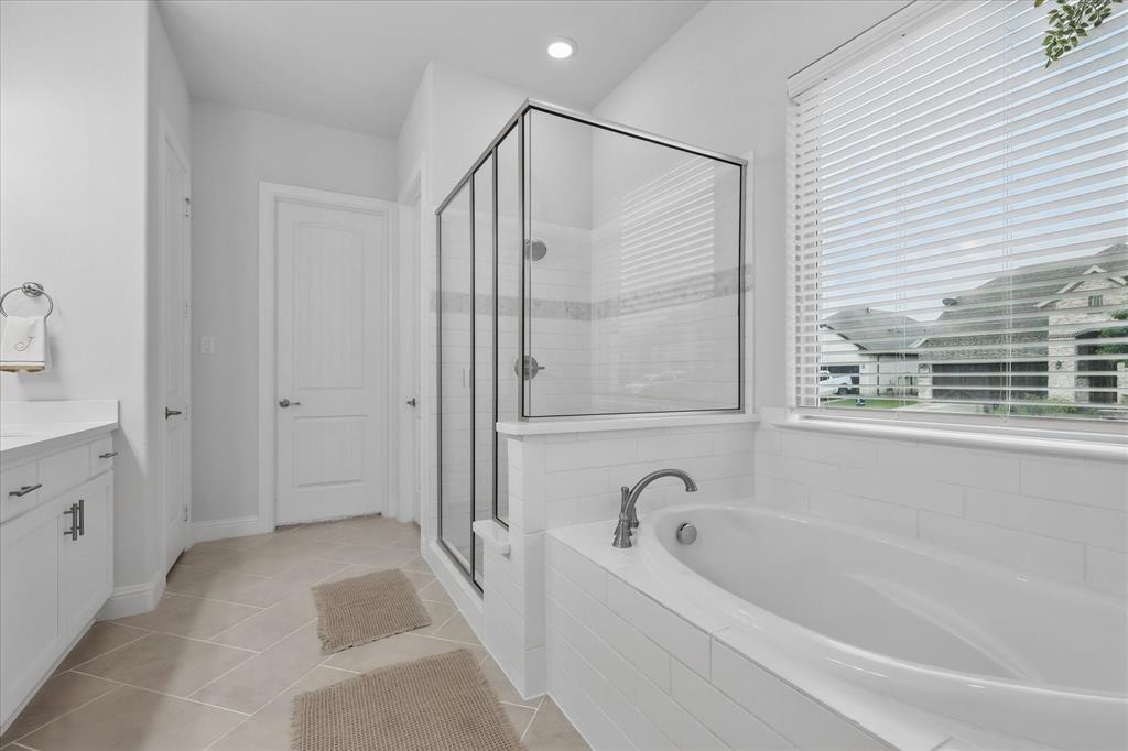 618 Race Drive Forney, TX 75126 - Photo 16 of 39 a bathroom with a bathtub and a shower