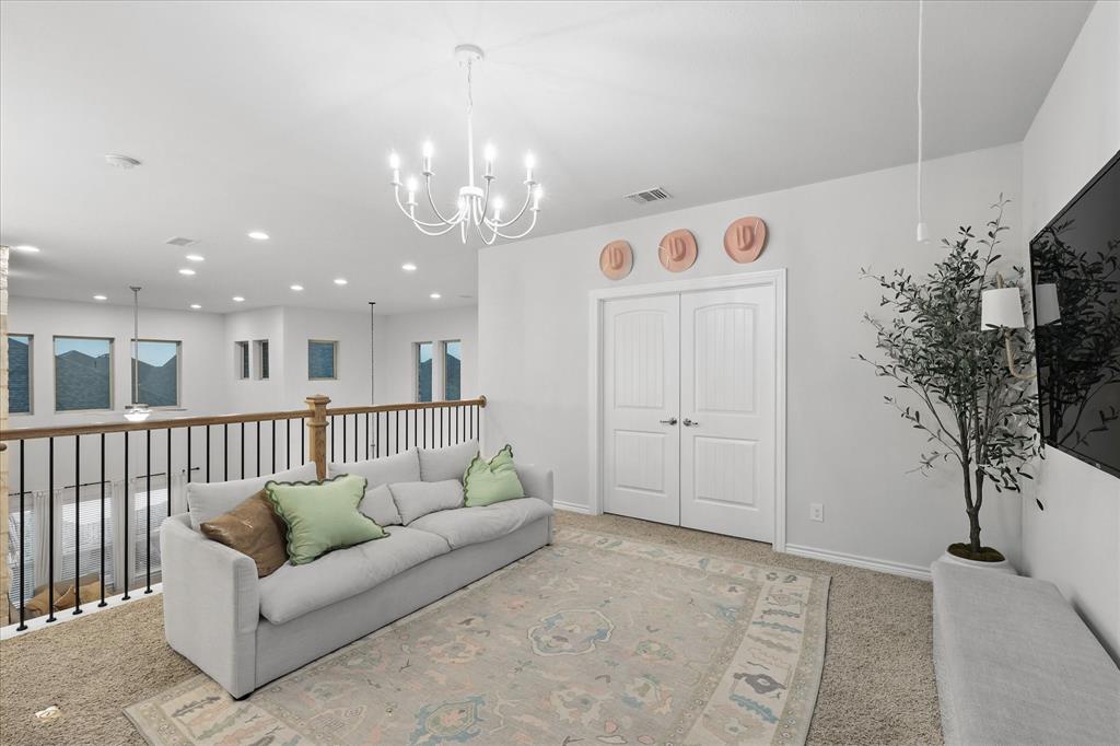 618 Race Drive Forney, TX 75126 - Photo 18 of 39 a living room with furniture and a chandelier