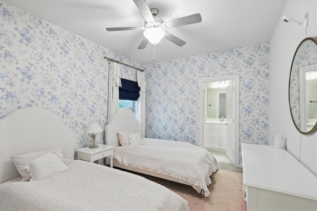 618 Race Drive Forney, TX 75126 - Photo 20 of 39 a bedroom with a bed a chandelier and a flat screen tv