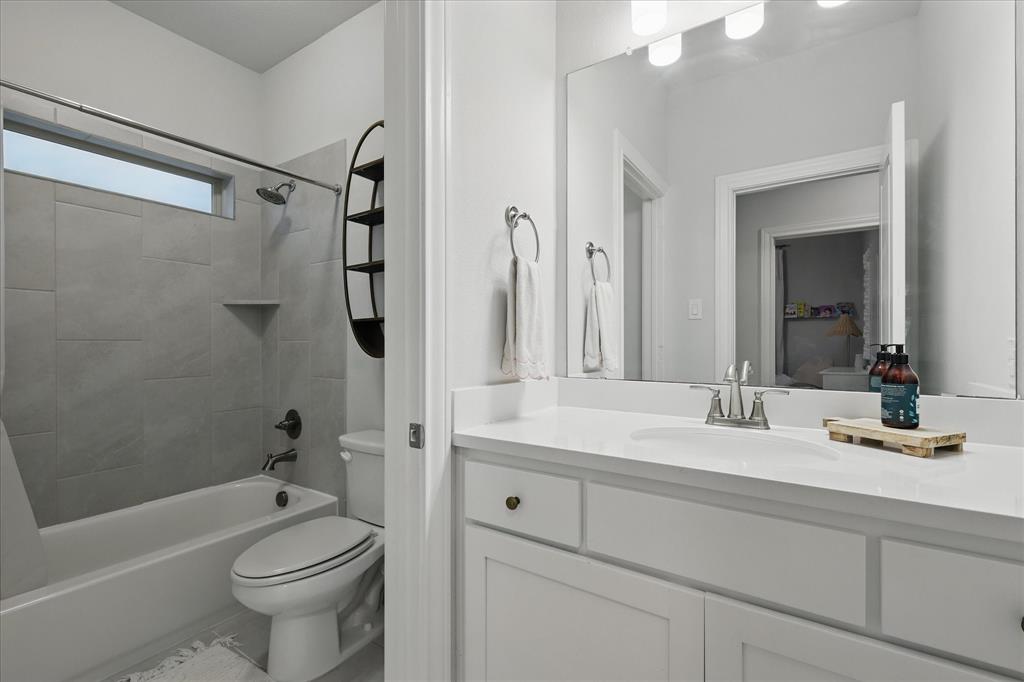 618 Race Drive Forney, TX 75126 - Photo 23 of 39 a bathroom with a sink a toilet and shower