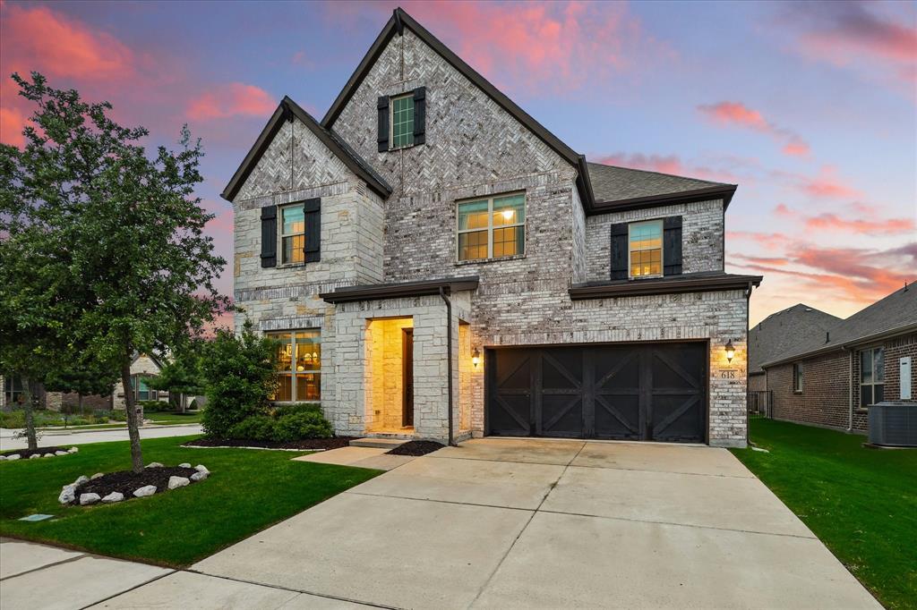 618 Race Drive Forney, TX 75126 - Photo 26 of 39 a front view of a house with a yard and garage