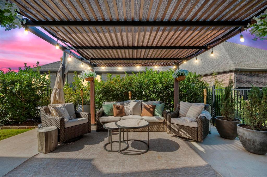 618 Race Drive Forney, TX 75126 - Photo 27 of 39 a patio with patio a table and chairs and potted plants