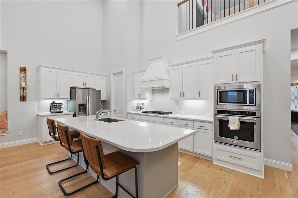 618 Race Drive Forney, TX 75126 - Photo 9 of 39 a kitchen with stainless steel appliances a stove a sink a microwave and a refrigerator