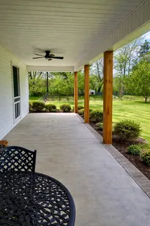 a front view of house with yard and outdoor seating