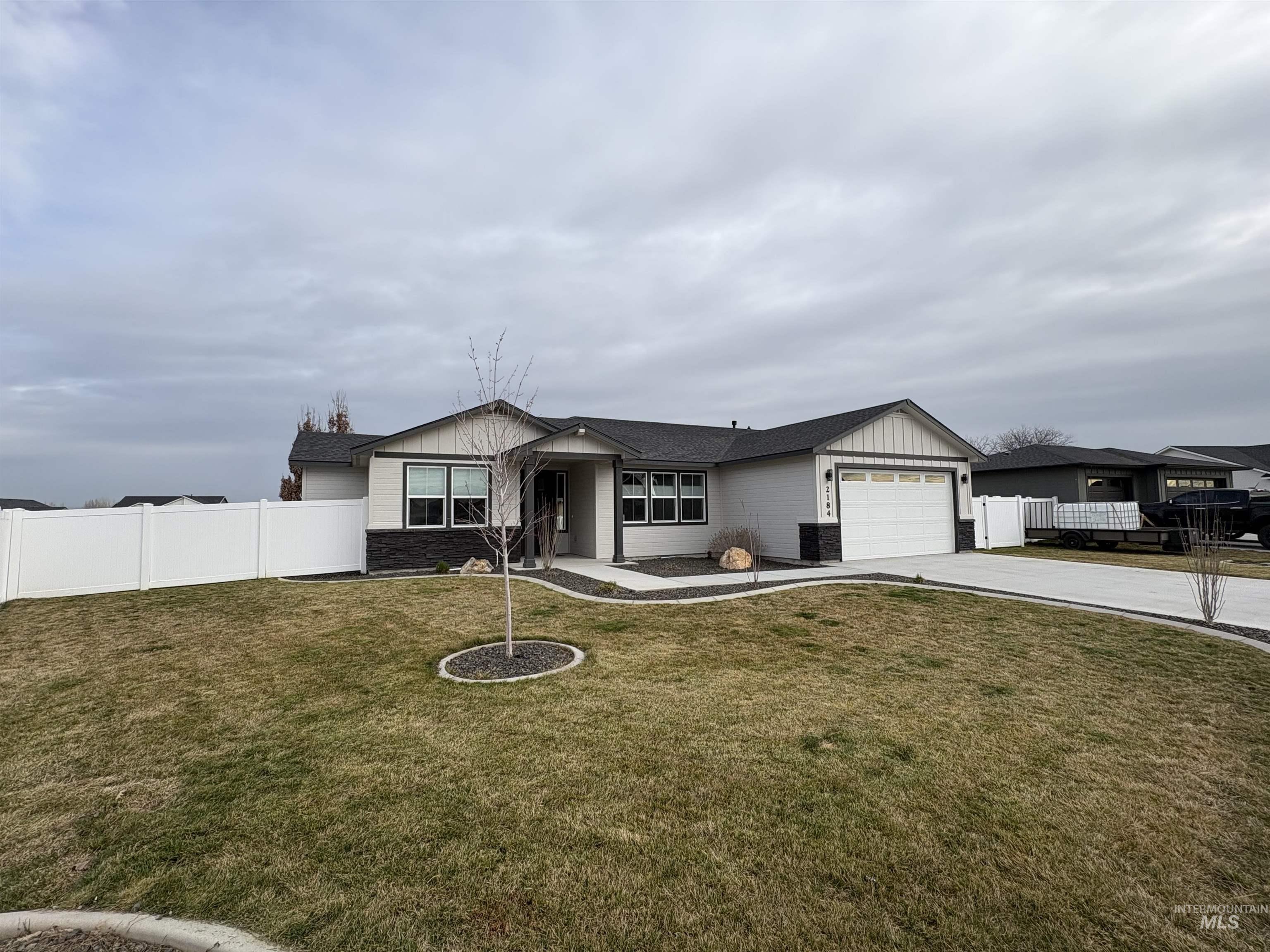 2184 Austin Way Fruitland, ID 83619 - Photo 1 of 34 Ranch-style house featuring driveway, an attached garage, and board and batten siding
