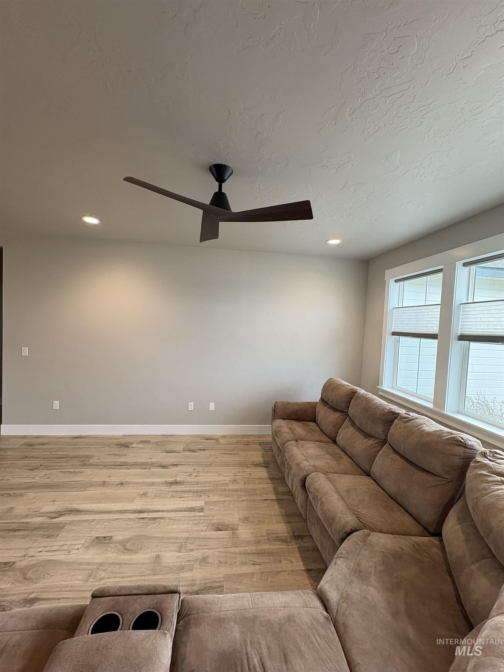 2184 Austin Way Fruitland, ID 83619 - Photo 16 of 34 Living area featuring light wood-style floors, ceiling fan, recessed lighting, and a textured ceiling