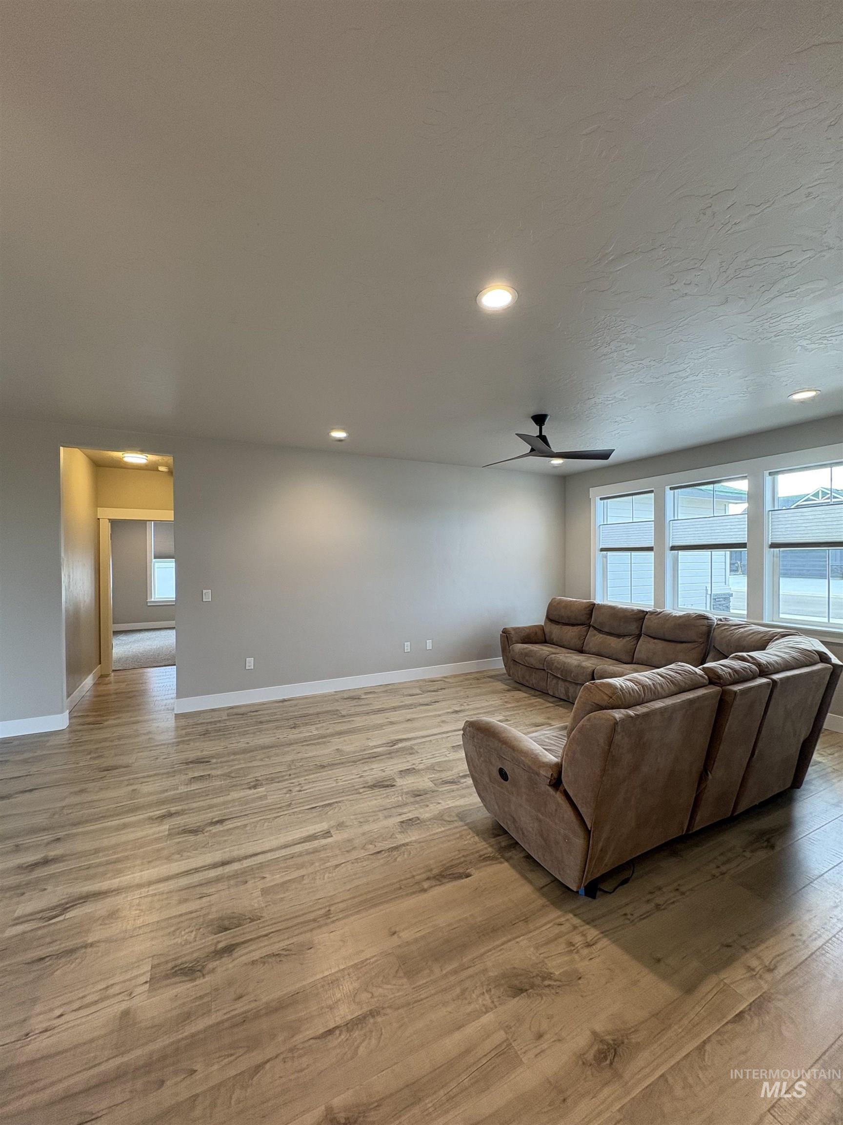 2184 Austin Way Fruitland, ID 83619 - Photo 18 of 34 Living area with a ceiling fan, recessed lighting, light wood finished floors, and plenty of natural light