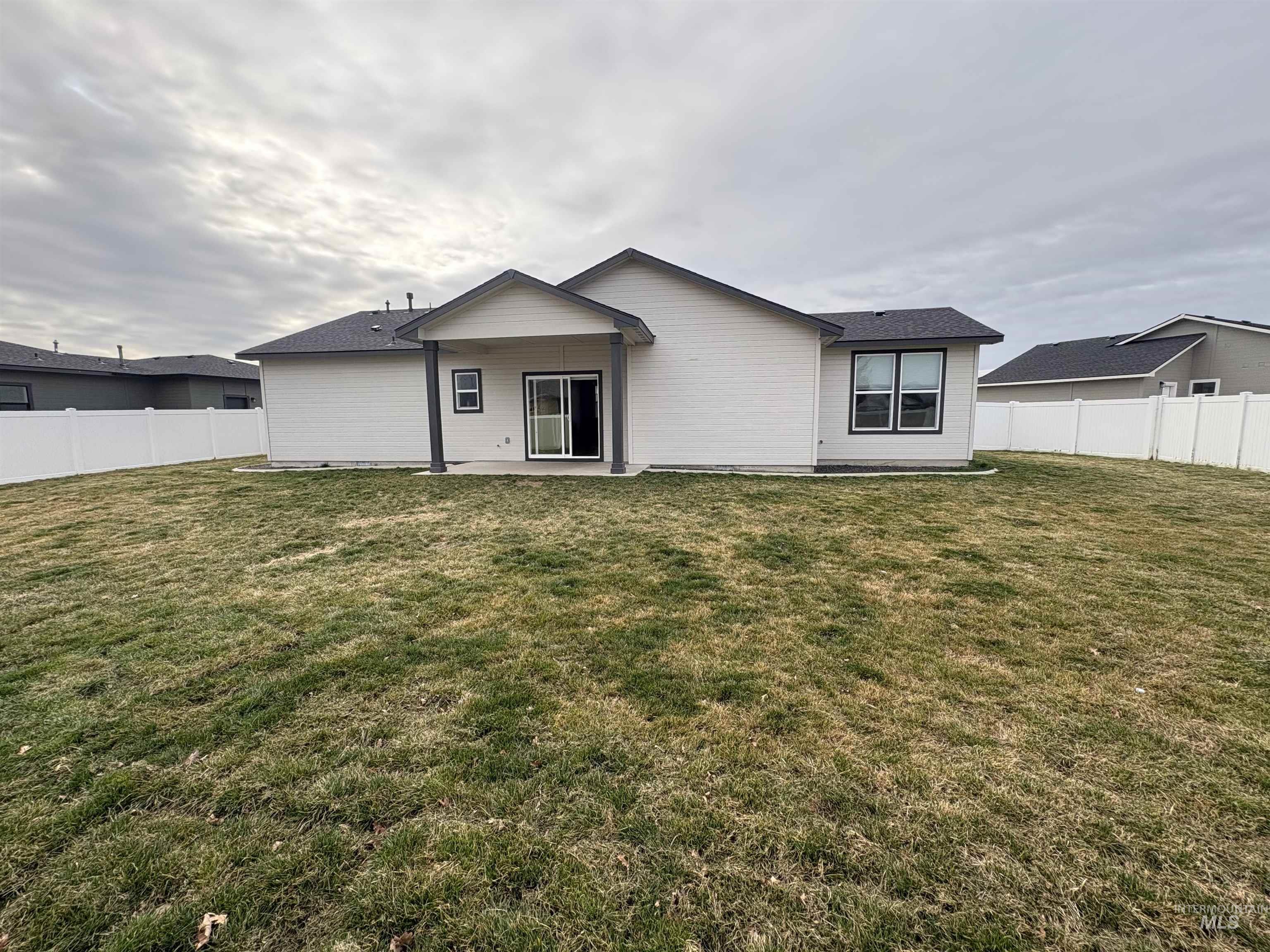 2184 Austin Way Fruitland, ID 83619 - Photo 3 of 34 Rear view of house featuring a fenced backyard and a patio area