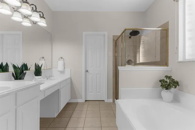 a bathroom with a bathtub sink and mirror