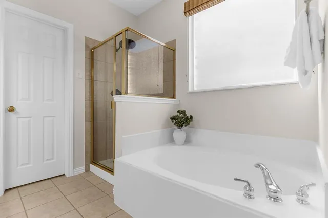 a bathroom with a tub and mirror