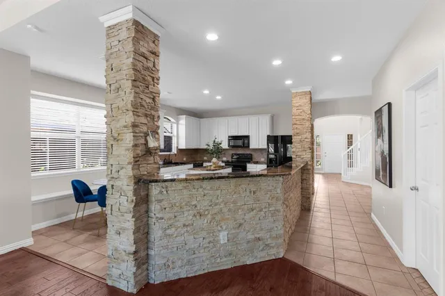 a view of kitchen with refrigerator microwave and wooden floor