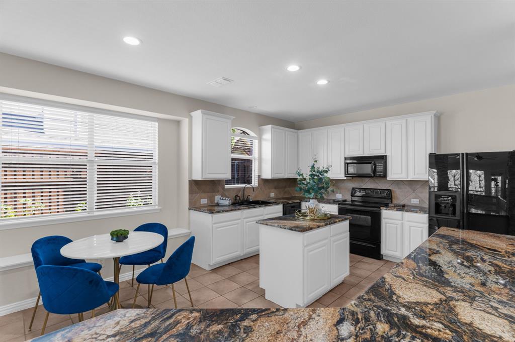 4607 Forest Park Road Plano, TX 75024 - Photo 21 of 40 a kitchen with a refrigerator and a stove top oven