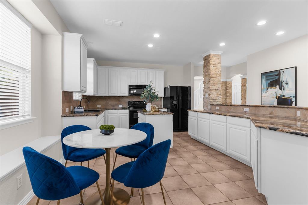 4607 Forest Park Road Plano, TX 75024 - Photo 25 of 40 a kitchen with stainless steel appliances granite countertop a sink a stove a kitchen island and chairs