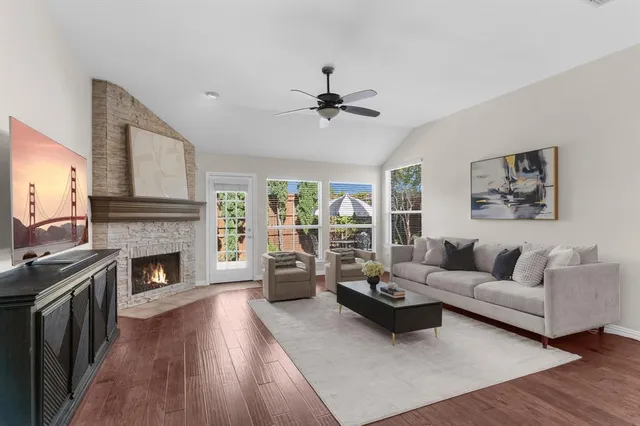 a living room with furniture fireplace and window