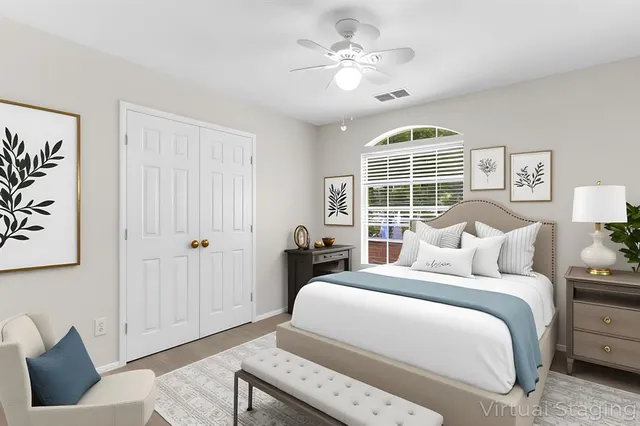 a spacious bedroom with a bed and a window