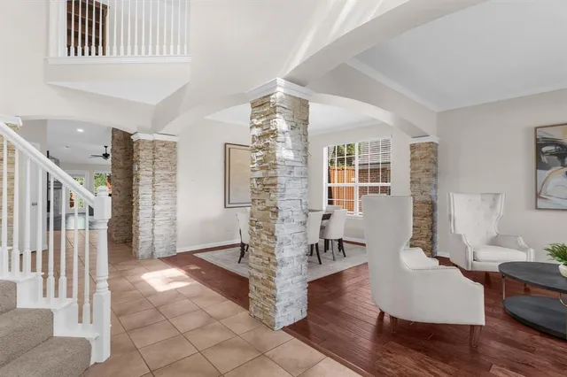 a living room with couches and glass door with wooden floor