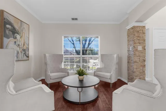 a living room with furniture and a potted plant