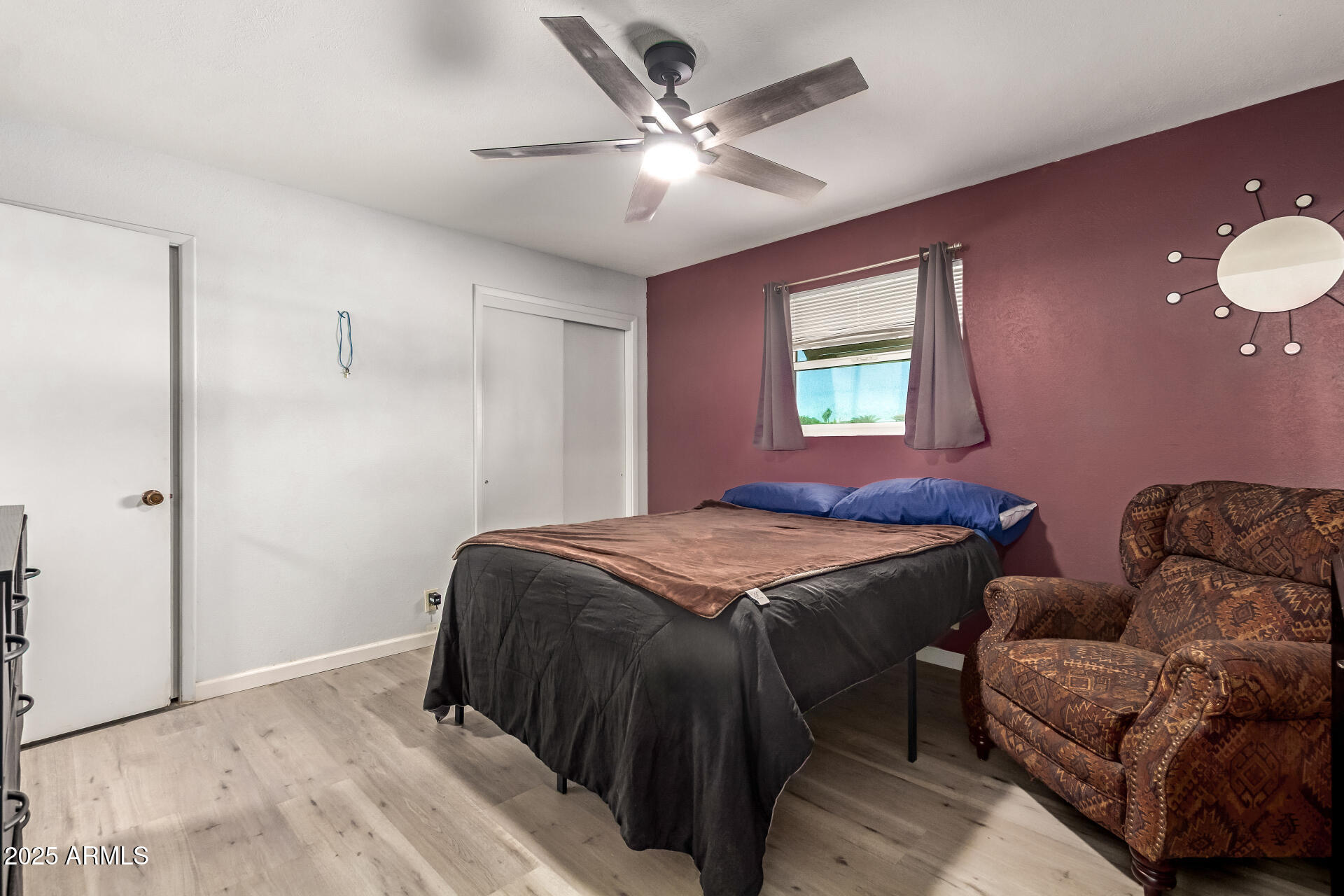 6149 East Decatur Street Mesa, AZ 85205 - Photo 13 of 24 a bedroom with a bed couch chandelier and a window