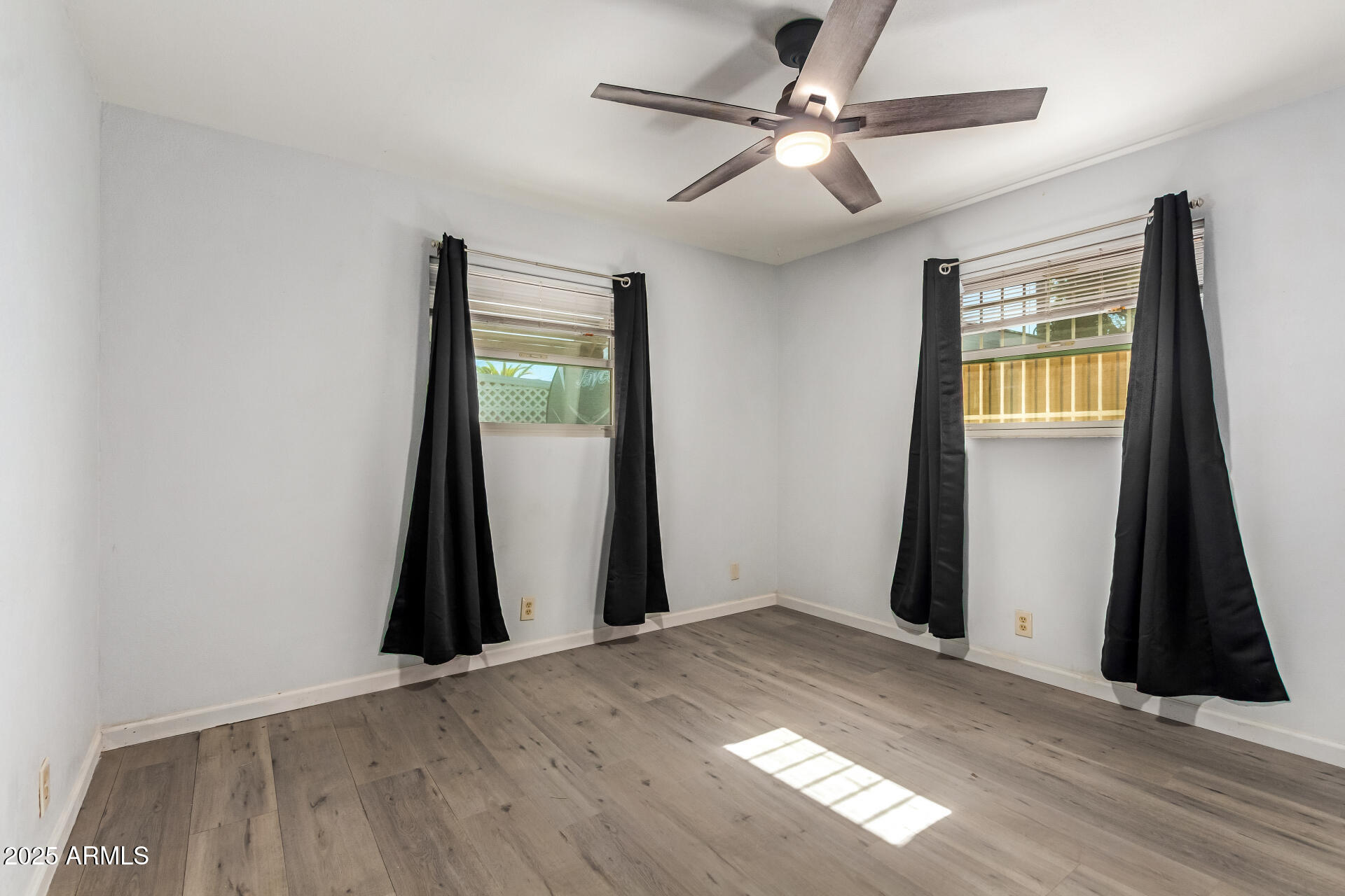 6149 East Decatur Street Mesa, AZ 85205 - Photo 17 of 24 wooden floor in an empty room with a window