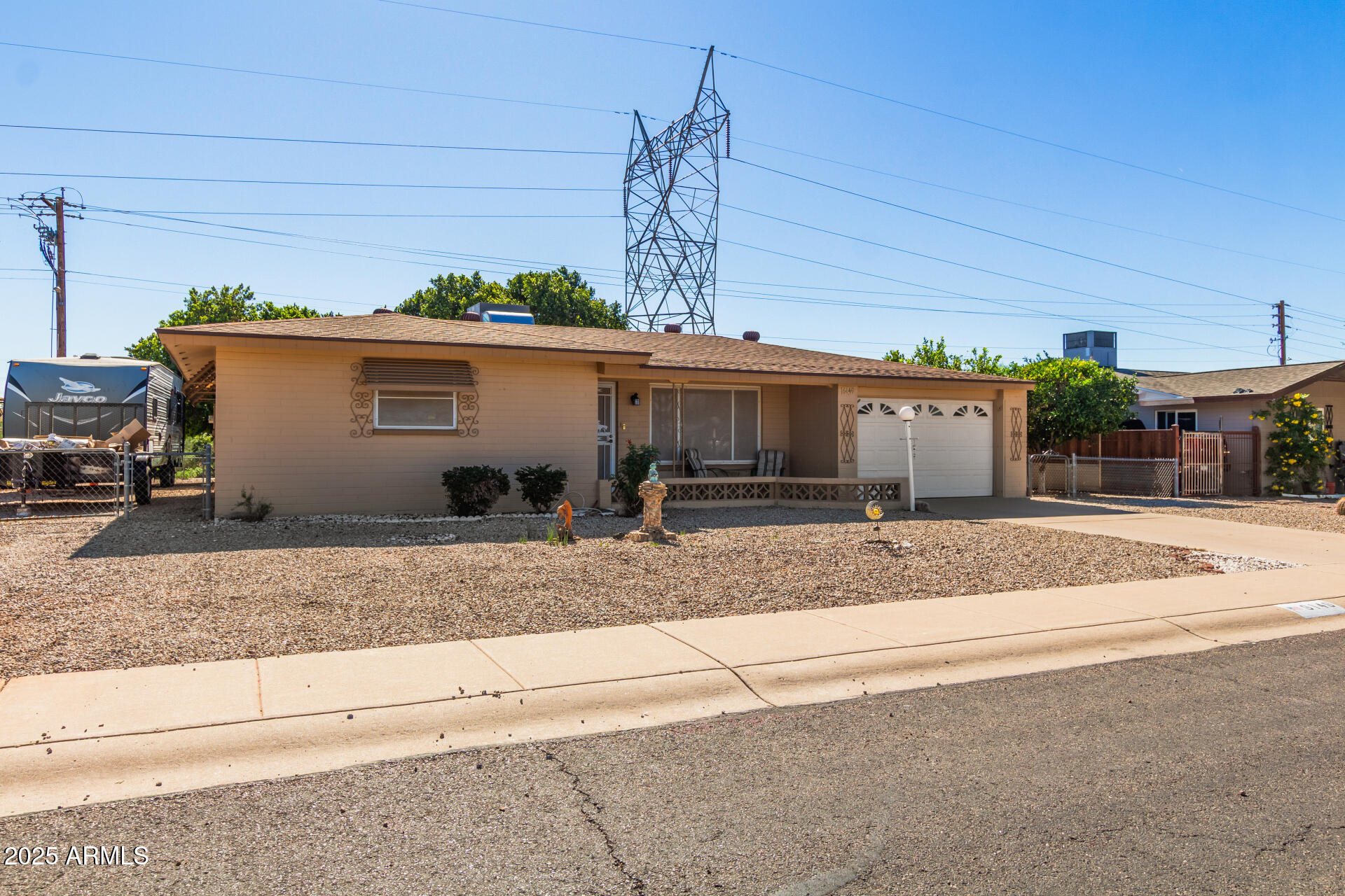 6149 East Decatur Street Mesa, AZ 85205 - Photo 2 of 24 a front view of a house with a yard and garage