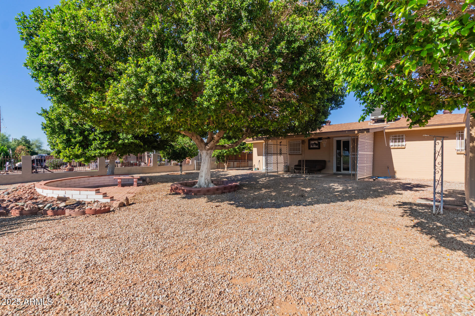 6149 East Decatur Street Mesa, AZ 85205 - Photo 22 of 24 a front view of a house with a yard and garage