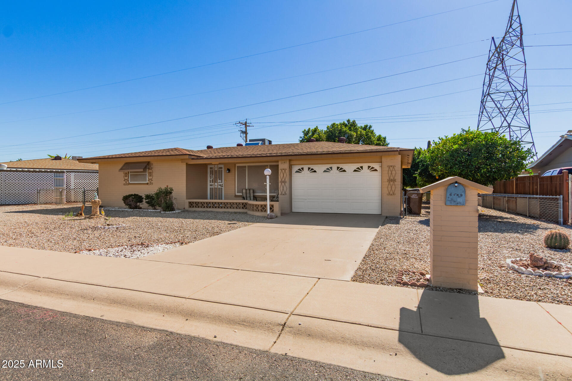 6149 East Decatur Street Mesa, AZ 85205 - Photo 3 of 24 a front view of a house with a yard