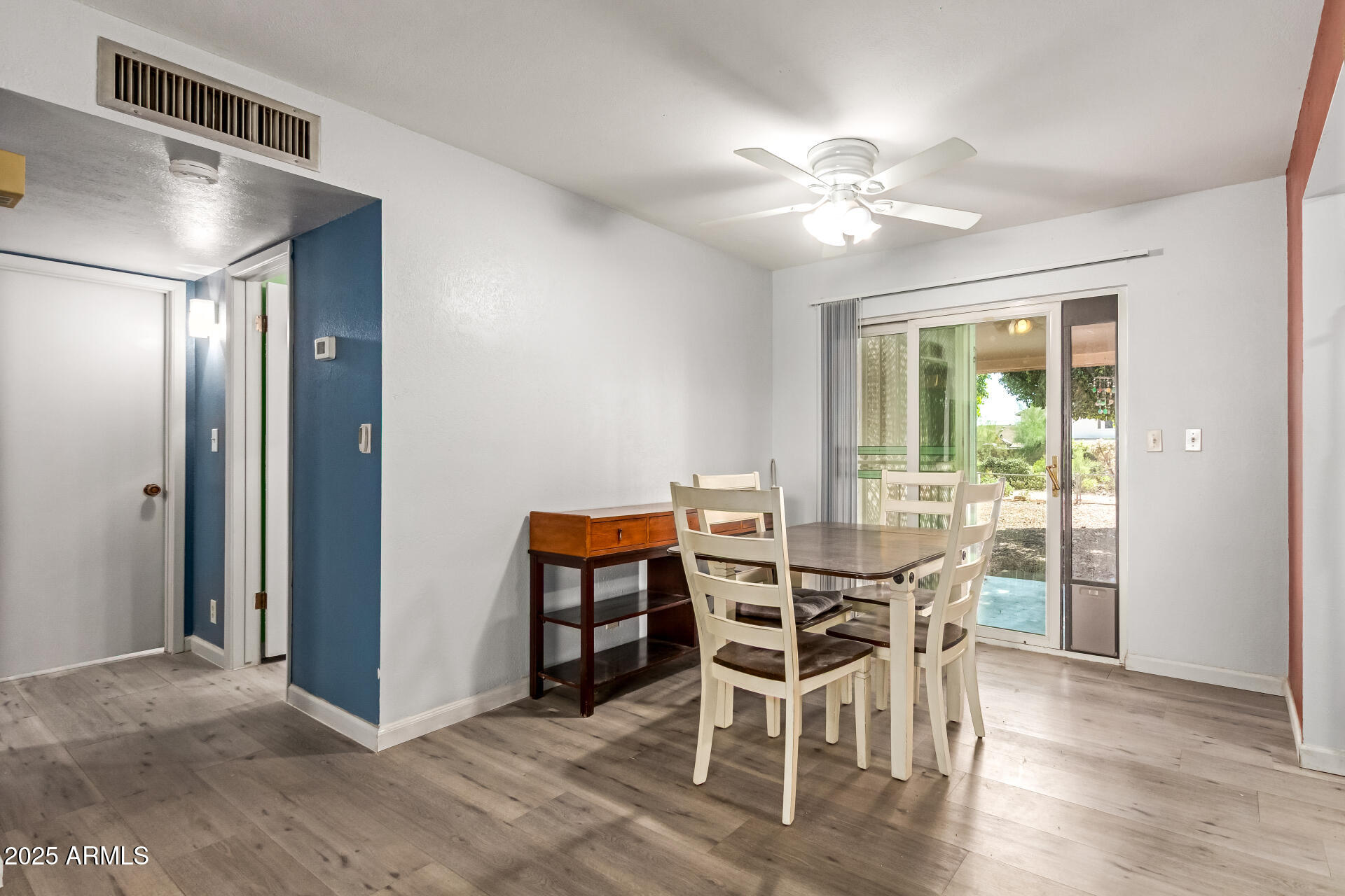 6149 East Decatur Street Mesa, AZ 85205 - Photo 8 of 24 a view of a dining room with furniture window and wooden floor