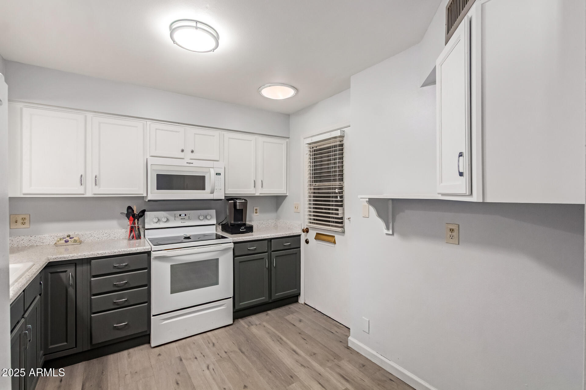 6149 East Decatur Street Mesa, AZ 85205 - Photo 10 of 24 a kitchen with a sink a stove and cabinets