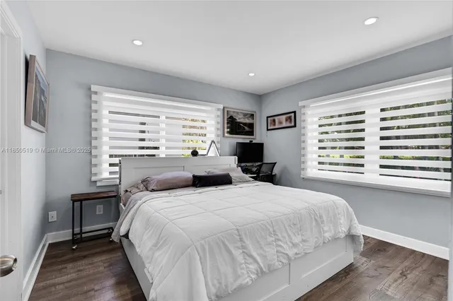 a bedroom with a large bed and a large window