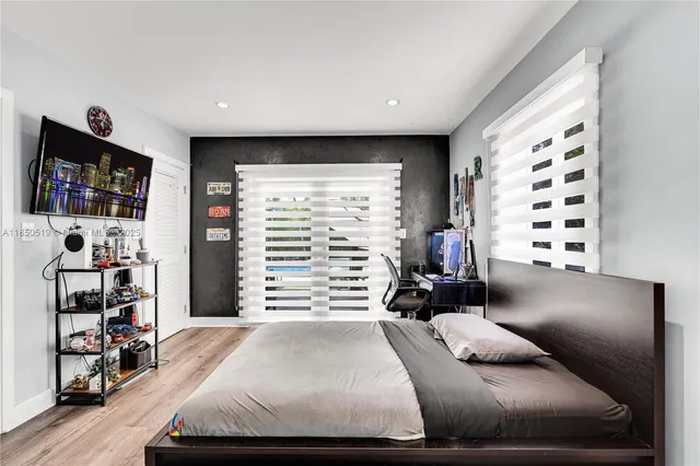 a bed room with a bed and a television