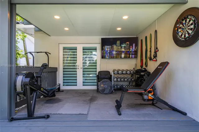 a view of a livingroom with workspace and a window