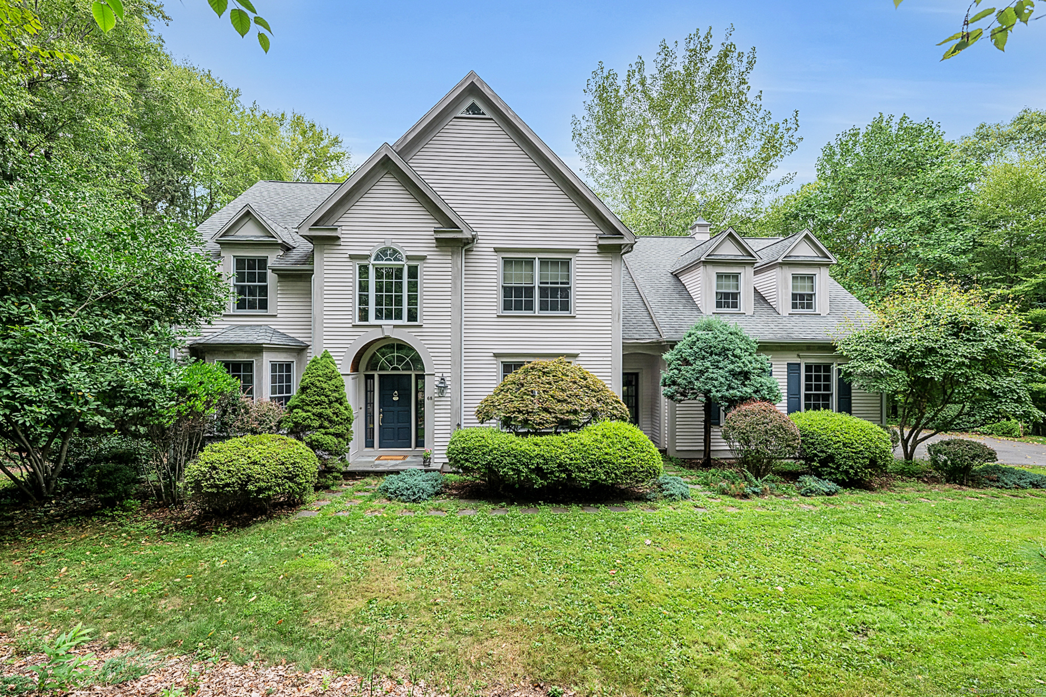 a front view of a house with a garden