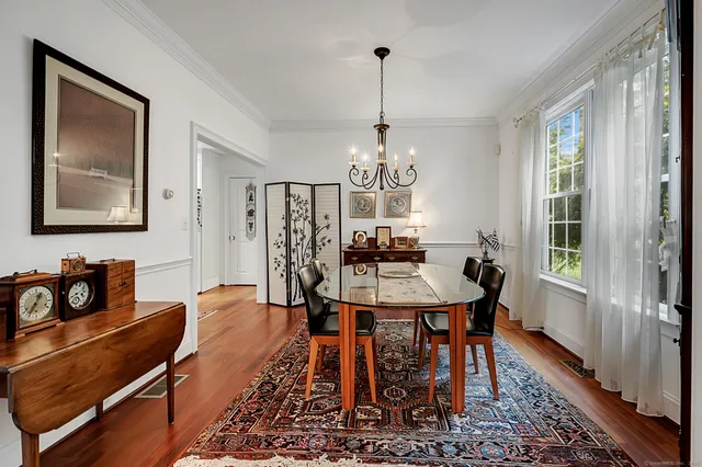 a view of a dining room with furniture window and wooden floor