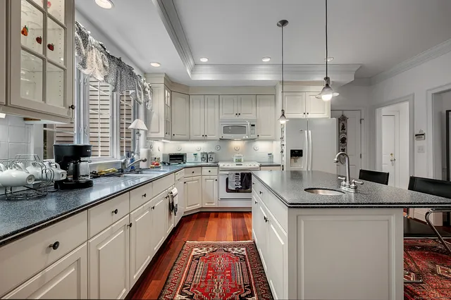 a kitchen with lot of counter top space cabinets and appliances