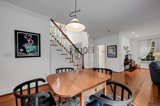 a view of a dining room with furniture and a potted plant