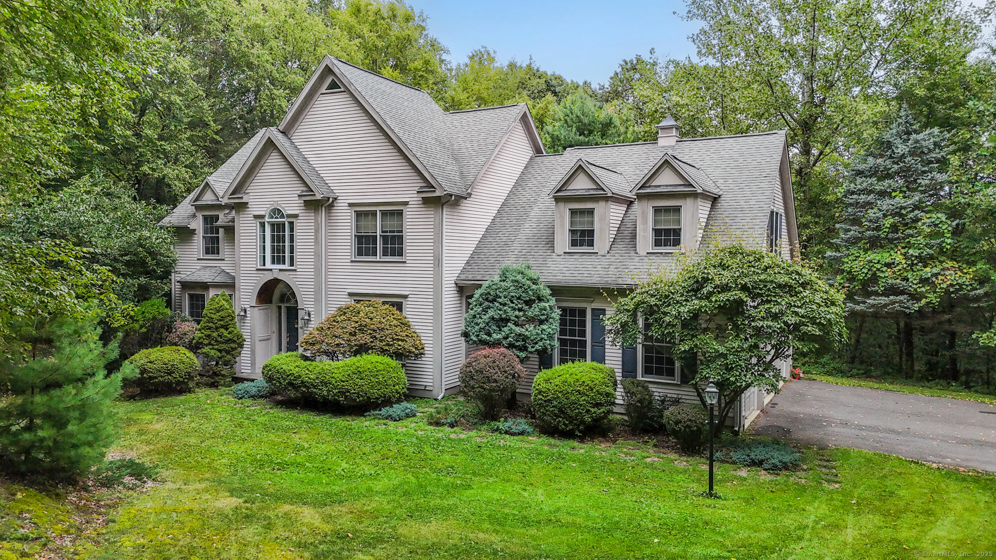 68 Hart Street Burlington, CT 06013 - Photo 2 of 39 a front view of a house with a garden