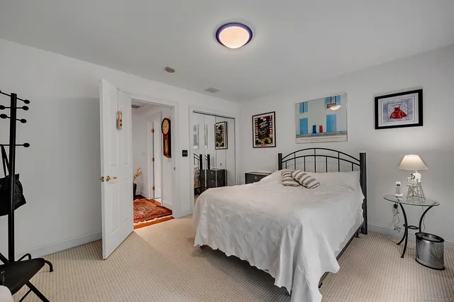 a bedroom with a bed and a table