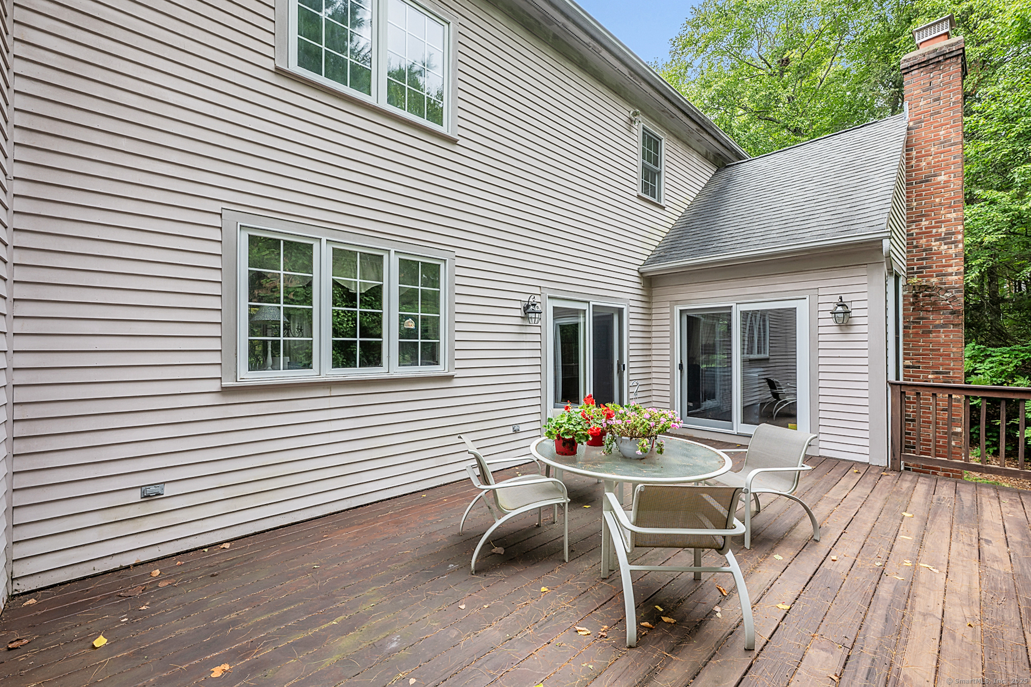 68 Hart Street Burlington, CT 06013 - Photo 36 of 39 a backyard of a house with wooden chairs and a barbeque