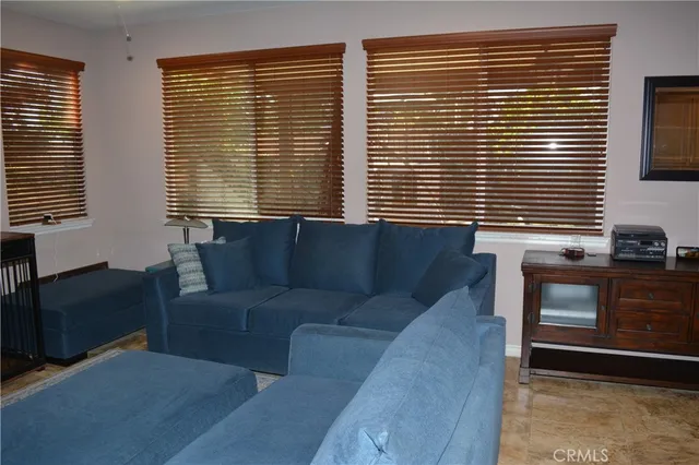 a living room with furniture next to a window