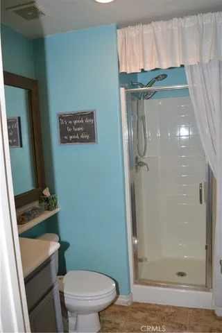 a bathroom with a toilet and a shower