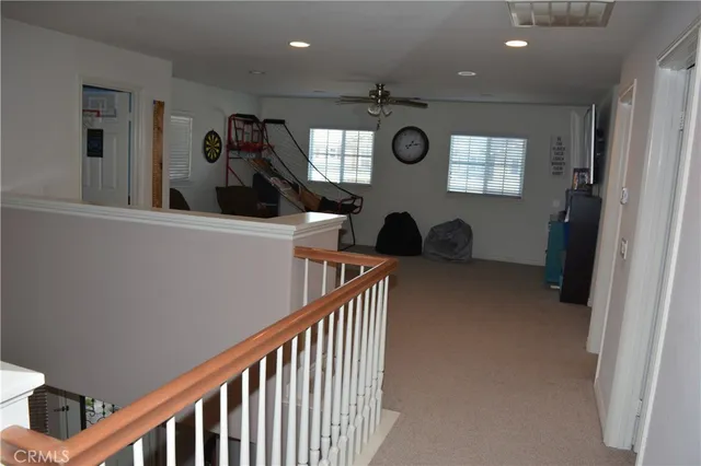 a view of hallway with furniture and a window
