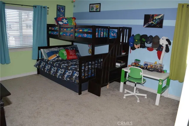 a bedroom with a bed a book shelf and a window