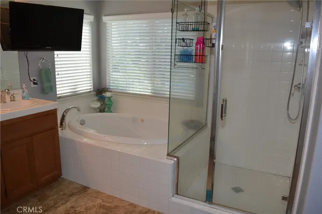 a bathroom with a bathtub and a shower