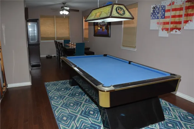 a bath room with a table chairs and wooden floor